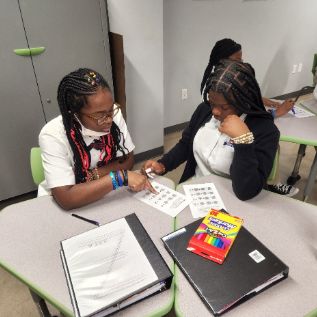  student working as partners at their desks